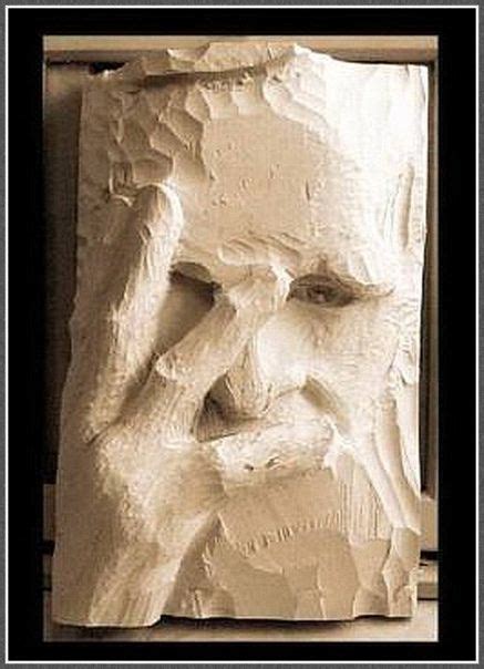 a sculpture of a man's face is shown in black and white