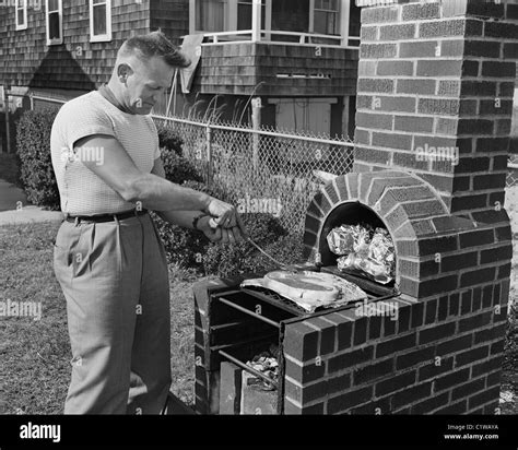 Man cooking barbecue Stock Photo - Alamy