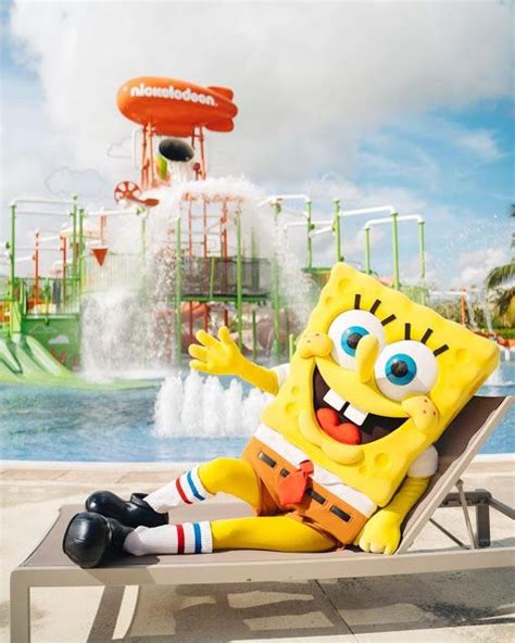 spongebob sitting on a lounge chair in front of a water park