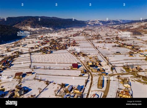 Aerial winter landscape of a traditional romanian village, Moldovita ...