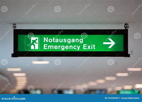 Illuminated Green Emergency Exit Sign Stock Photo - Image of hanging ...