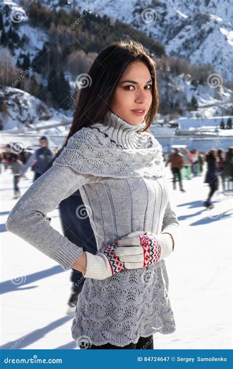 Pretty Woman Ice Skating Winter Outdoors, Smiling Facial. Mountains in the Background Stock ...