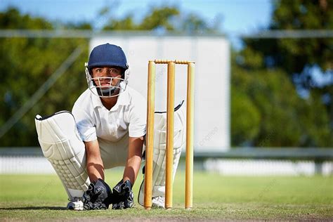 Male Wicket Keeper Playing Cricket With Gear On Pitch Photo Background ...