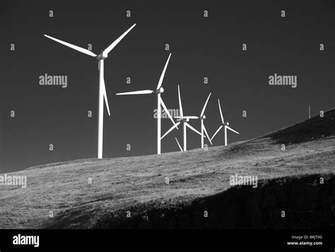 Alternative green energy rotary wind turbines on the hillside Stock Photo - Alamy