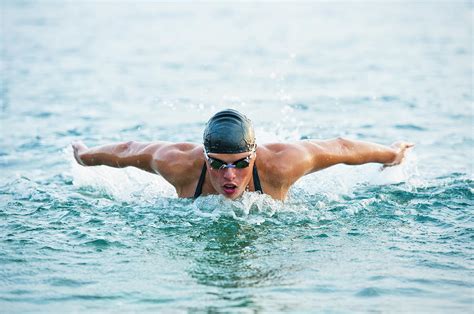 Female Swimmer At Butterfly Stroke In Photograph by Technotr - Pixels