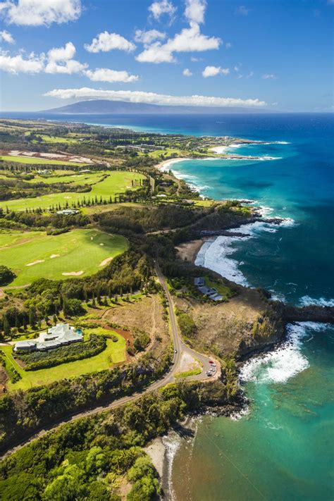 an aerial view of the ocean and golf course