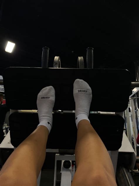 Dark gym aesthetic with white nike socks on a leg press machine. Gym ...