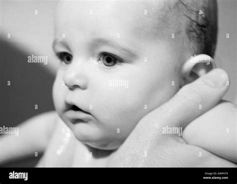Adult's hands holding baby under arms, close-up, b&w Stock Photo - Alamy
