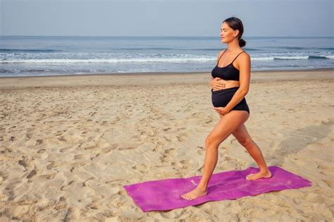 Premium Photo | Pregnant woman on the beach doing yoga