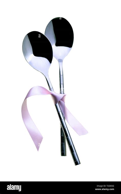 Two spoons tied together with pink ribbon. On a white background Stock Photo - Alamy