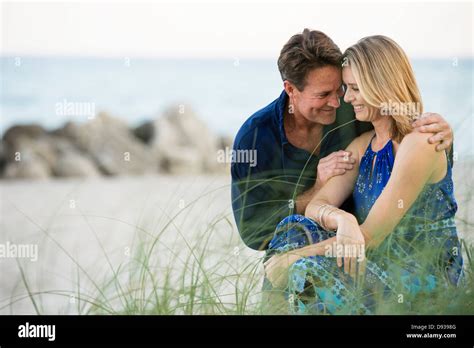 Couple smiling together on beach Stock Photo - Alamy