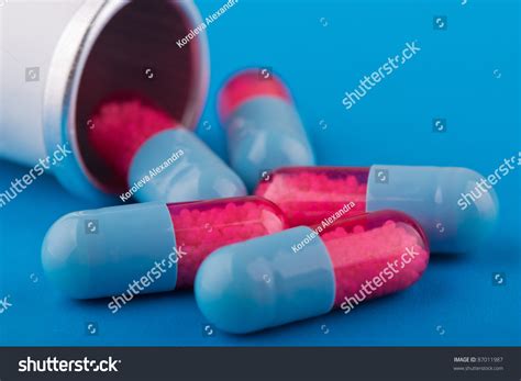 Capsules (Pills) Are Blue And Red Scattered On A Blue Background Stock ...