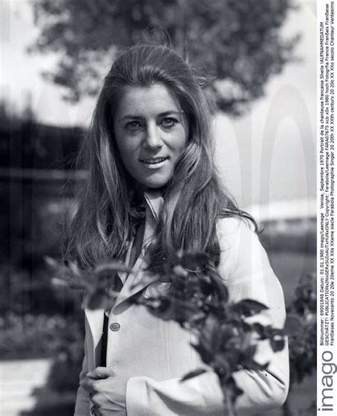 black and white photograph of a woman with long hair holding a plant in ...