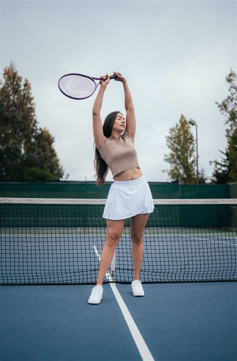 Woman Sitting and Posing on Tennis Court · Free Stock Photo