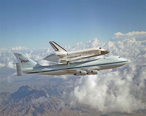 The nasa space shuttle being transported atop the nasa modified Boeing ...