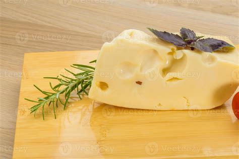 Maasdam cheese on wooden background 10866365 Stock Photo at Vecteezy