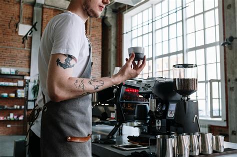 Man in White T-shirt Pouring Coffee on Black Coffee Maker · Free Stock Photo