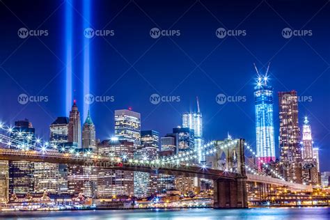 Brooklyn Bridge and Freedom Tower at night with 911 beams over city sk – NY Clips