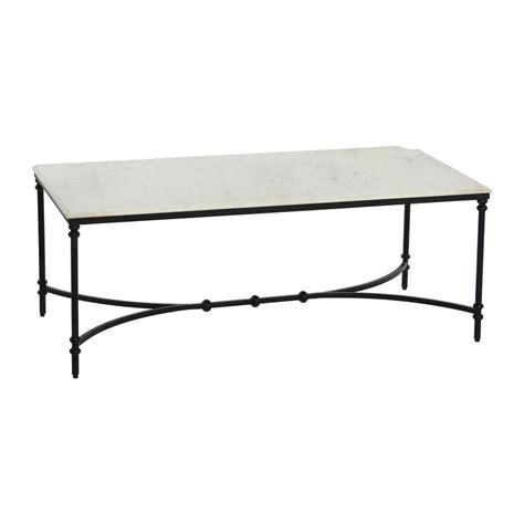 a white marble top coffee table with black iron frame and metal legs, on a white background