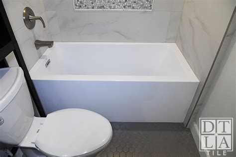 Inglewood bathtub surround installation with Schluter Trim - Tile Installation and Stone Fabrication