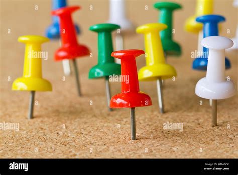 Group of colorful push pins on cork bulletin board Stock Photo - Alamy