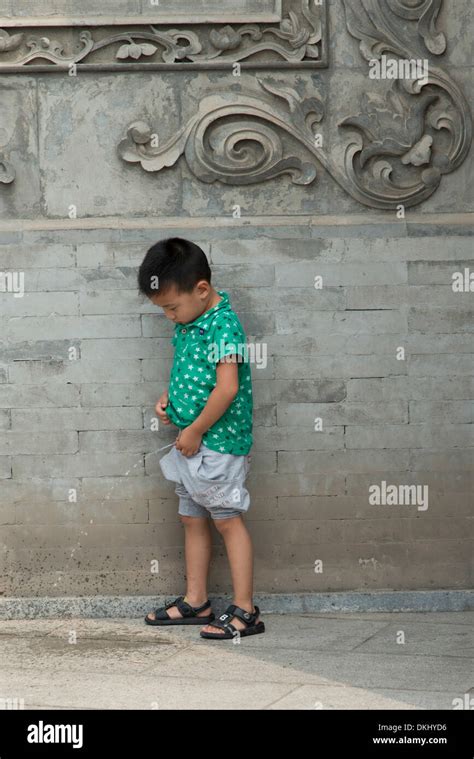 Boy urinating on floor, Xi'an, Shaanxi, China Stock Photo - Alamy