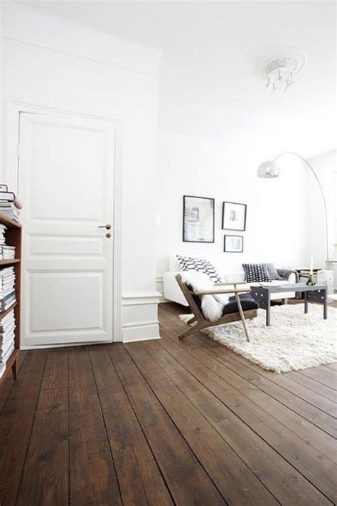 a living room with wood floors and white walls