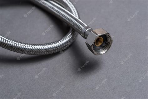 Premium Photo | Braided stainless steel water hose over grey background