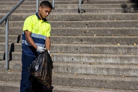 Premium Photo | Latino male garbage collector in work uniform ...