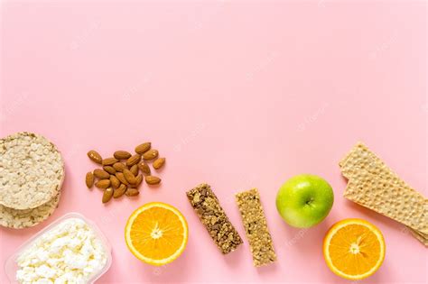 Premium Photo | Flat lay of various healthy snacks on pink background