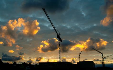 Jib crane at a construction site on a background of clouds wallpapers and images - wallpapers ...