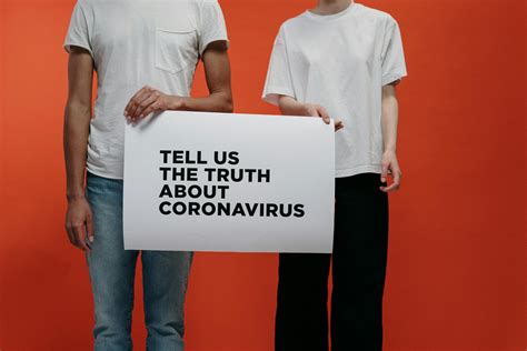 People Holding A Poster Asking About Facts On Coronavirus · Free Stock Photo