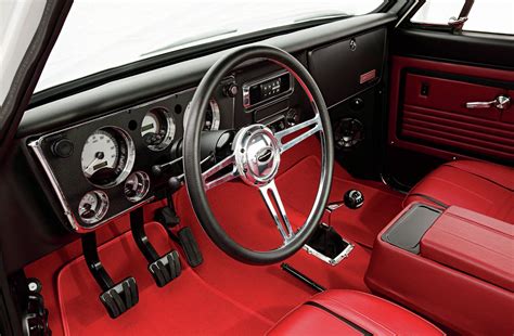 the interior of a classic car with red leather seats and steering wheel, including dashboard