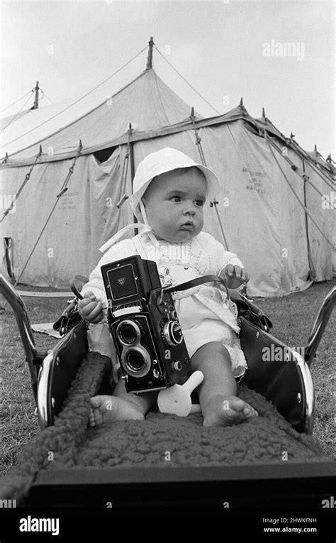 A baby sitting with a Rolleiflex camera at Skelton annual baby show. Circa 1973 Stock Photo - Alamy