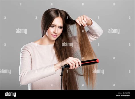 Ironing hair hi-res stock photography and images - Alamy