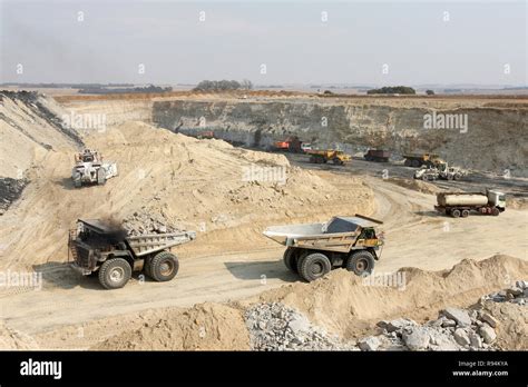 Open Pit Coal Mining - Large Rock Dump Trucks and Excavators digging ...