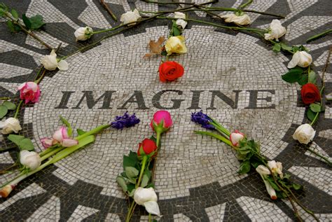 flowers laid out in the middle of a mosaic design with imagine written on it's side