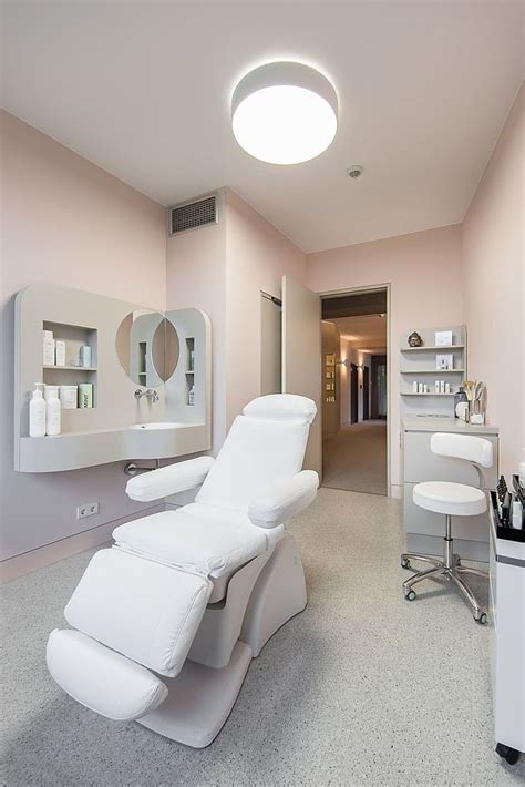 a white chair sitting in the middle of a room next to a sink and mirror