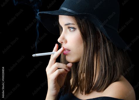 Portrait of the beautiful elegant girl smoking cigarette Stock Photo ...