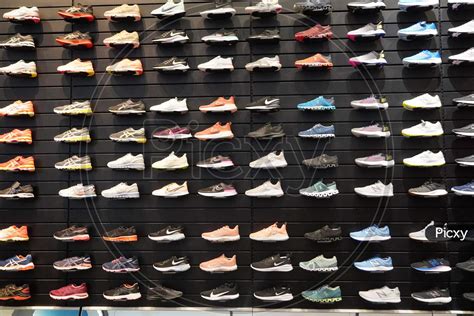 Image of Shop Display Of A Lot Of Sports Shoes On A Wall. A View Of A Wall Of Shoes Inside The ...