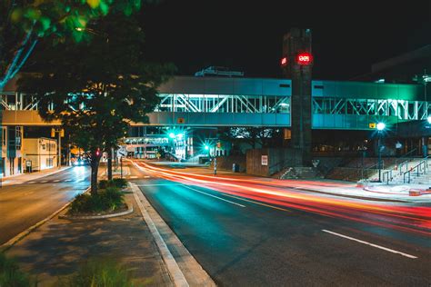 City road with pedestrian overpass at night · Free Stock Photo