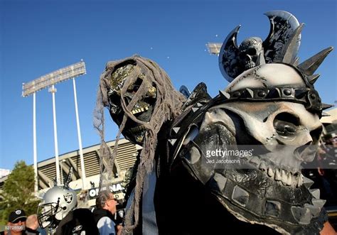 An Oakland Raider fan walks around the stadium before the Denver ...