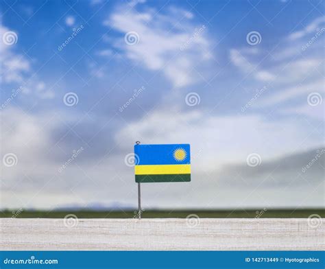 Rwandan Flag with Vast Meadow and Blue Sky Behind it. Stock Image ...