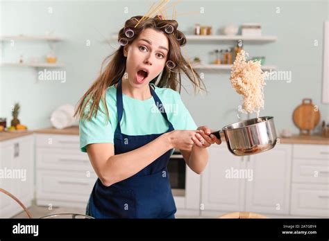 Funny young housewife cooking in kitchen Stock Photo - Alamy