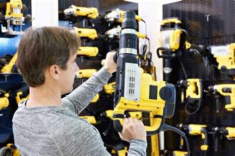 Man with Hammer Drill in Hardware Store Stock Image - Image of hardware ...