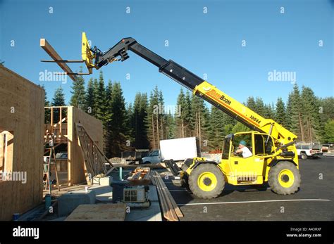 Construction - Operator of Highlift Crane With Forklift Moves Wood ...