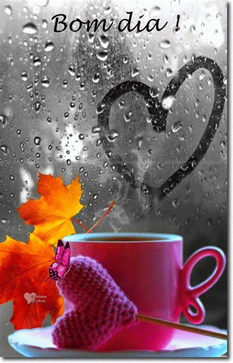 a cup and saucer sitting on top of a table next to a window covered in rain