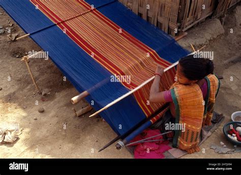 Using a traditional loom, a Chakma woman from a minority tribe, weaves ...