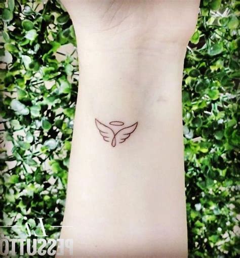 small-angel-wings-tattoo-wrist-tattoo-green-bushes-in-the-background ...