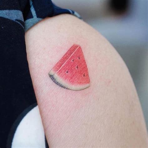 Watercolor watermelon tattoo on the shoulder.